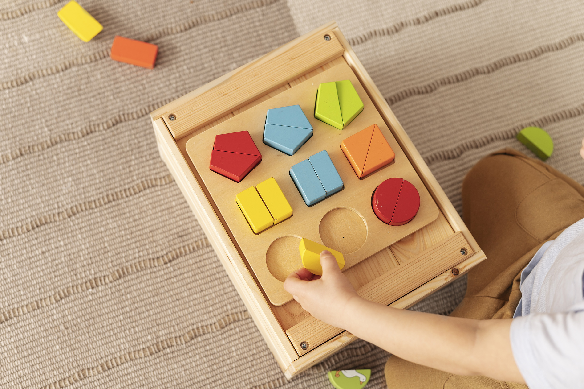 high angle kid playing with wooden toy